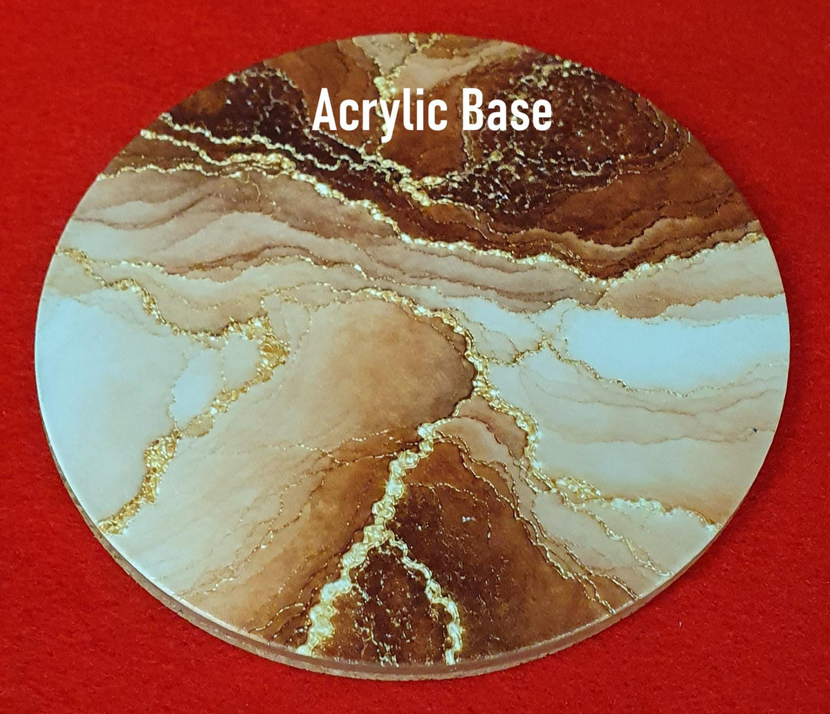 Terracotta marble effect coaster with textured gold veining held in hand, round 10cm cork backed drink coaster warm home decor