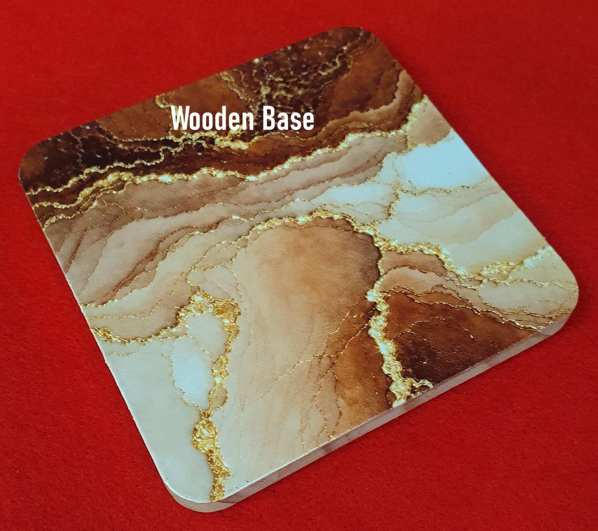 Terracotta marble effect coaster with textured gold veining held in hand, round 10cm cork backed drink coaster warm home decor