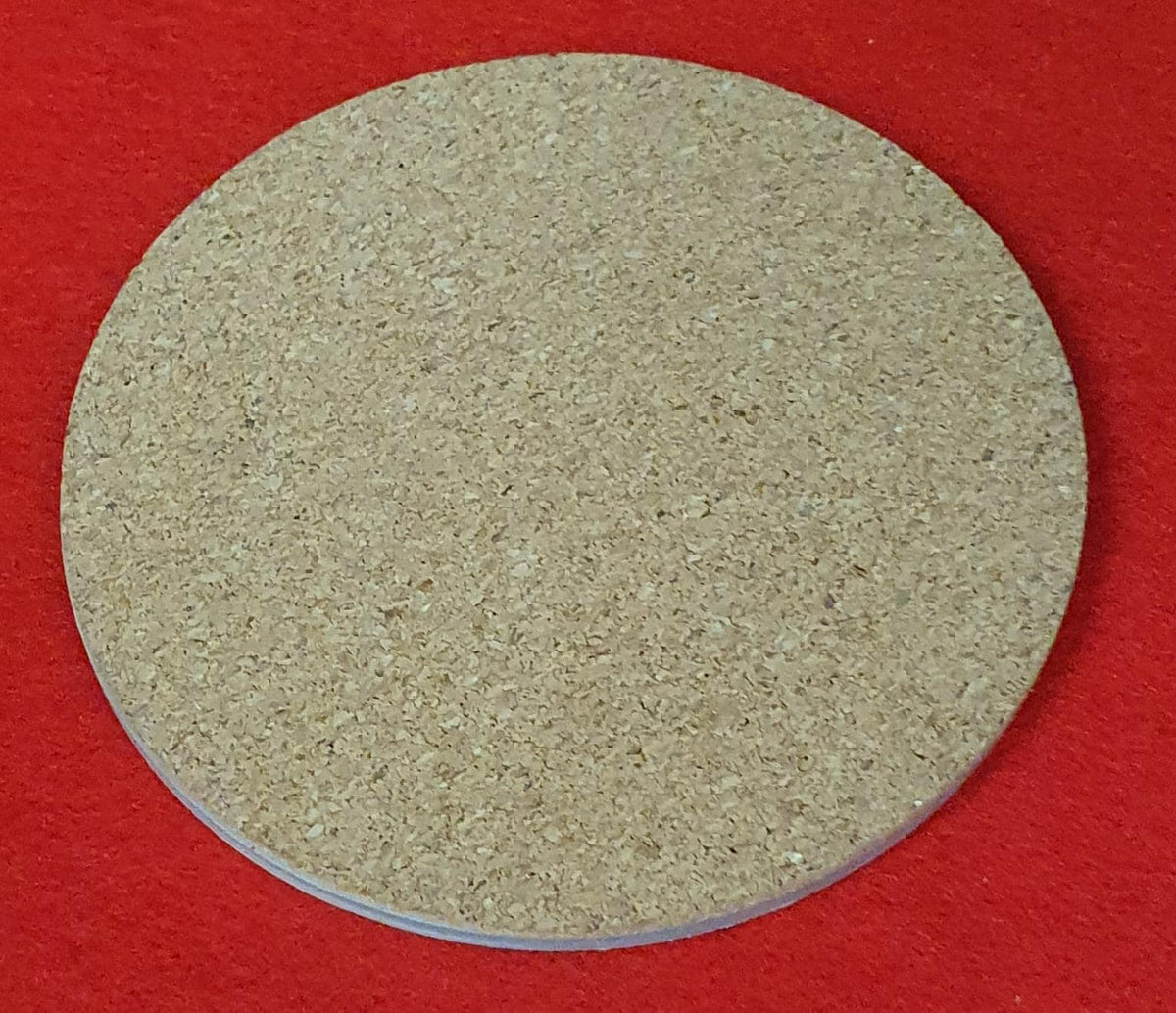 Terracotta marble effect coaster with textured gold veining held in hand, round 10cm cork backed drink coaster warm home decor