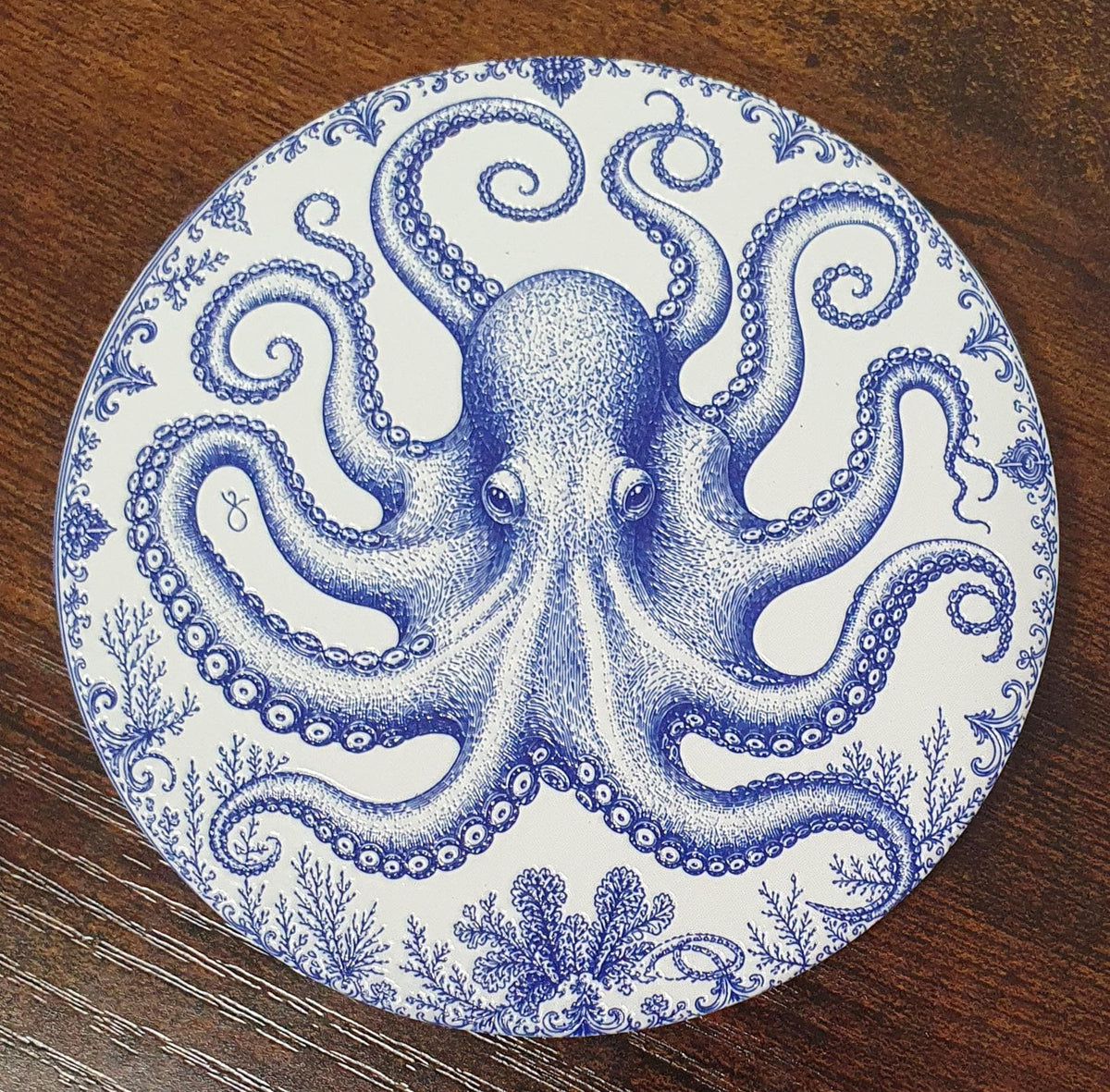 Blue and white ceramic coastal coasters presented as an elegant marine-themed gift set.