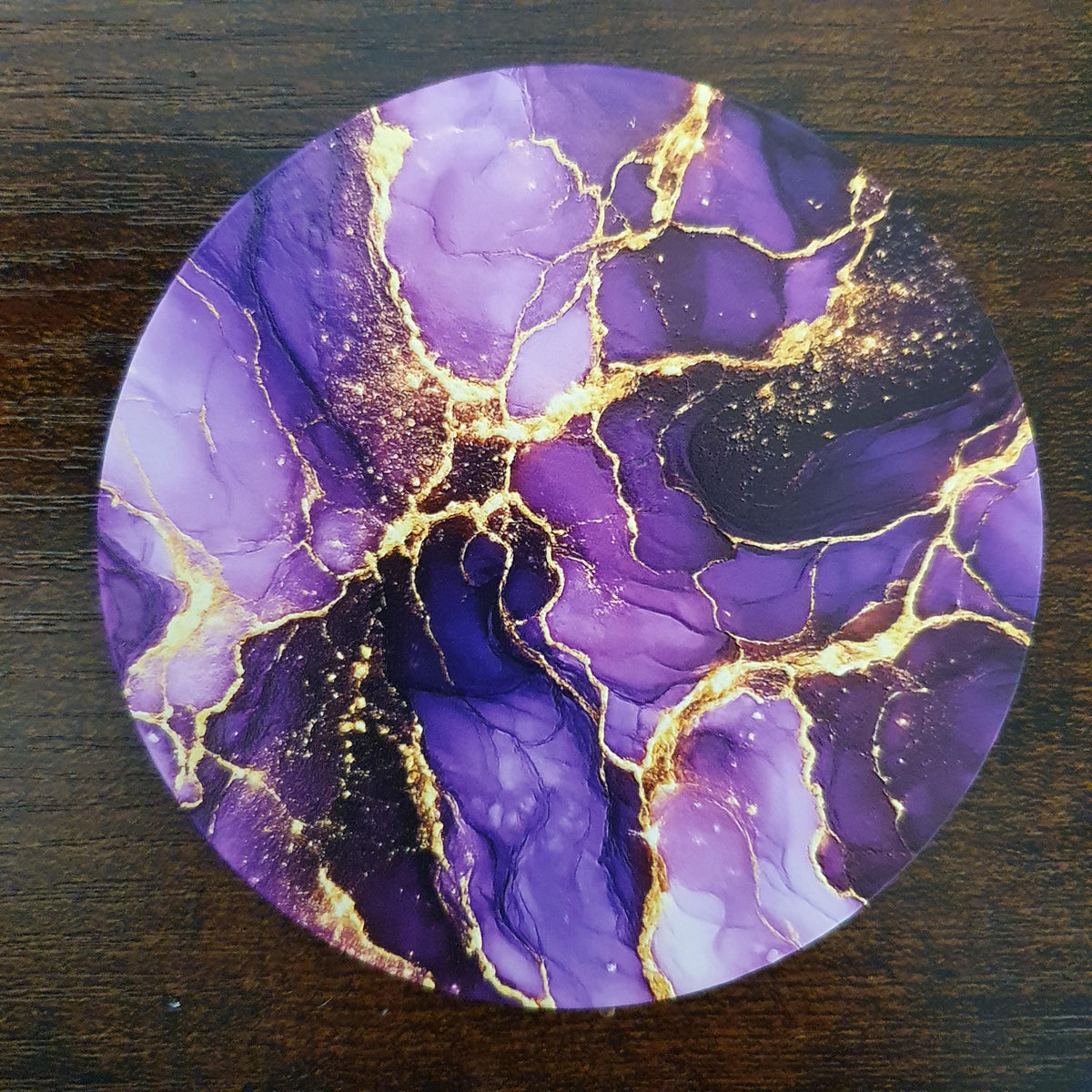 Premium 10cm purple abstract marble coaster featuring rich violet tones and sparkling metallic gold veining. Available in Acrylic, Wood or Ceramic with a glossy finish, ideal for protecting surfaces while adding stylish contemporary décor.
