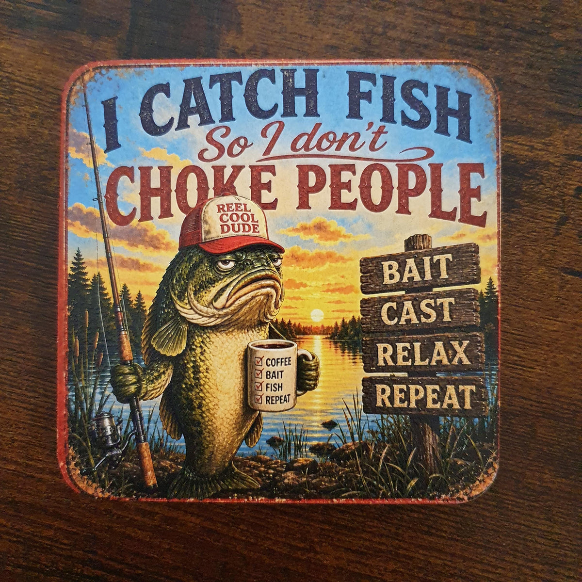 Vintage-style wooden fishing coaster showing a fish holding a fishing rod and coffee mug with the quote "I Catch Fish So I Don't Choke People", complete with textured UV print and rubber feet.