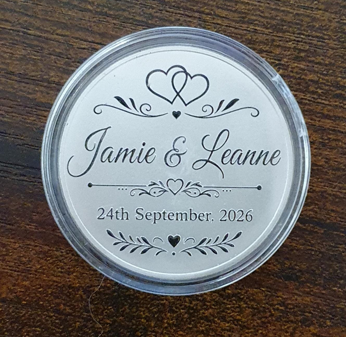 Solid alloy 40mm personalised wedding token displayed in protective acrylic presentation case
