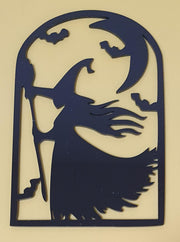 Black laser-cut acrylic Halloween decoration featuring a witch stirring a bubbling cauldron beneath a crescent moon and flying bats.
