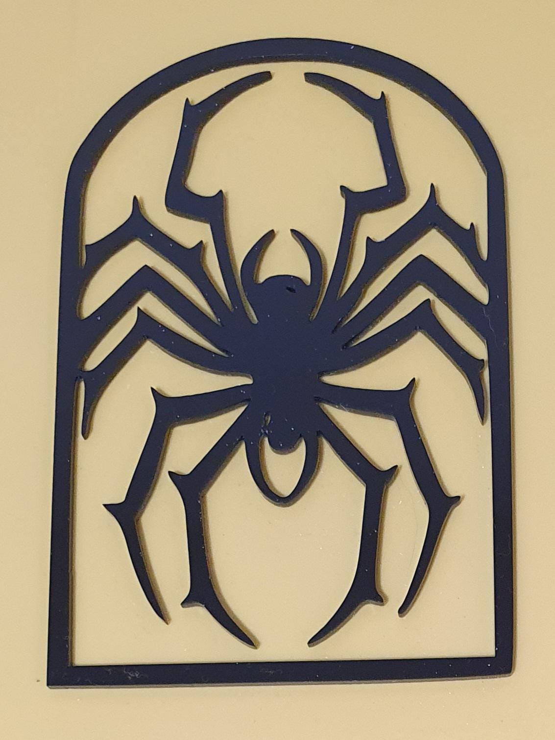 Black laser-cut acrylic Halloween decoration featuring a large creepy spider silhouette enclosed within a gothic arched frame.