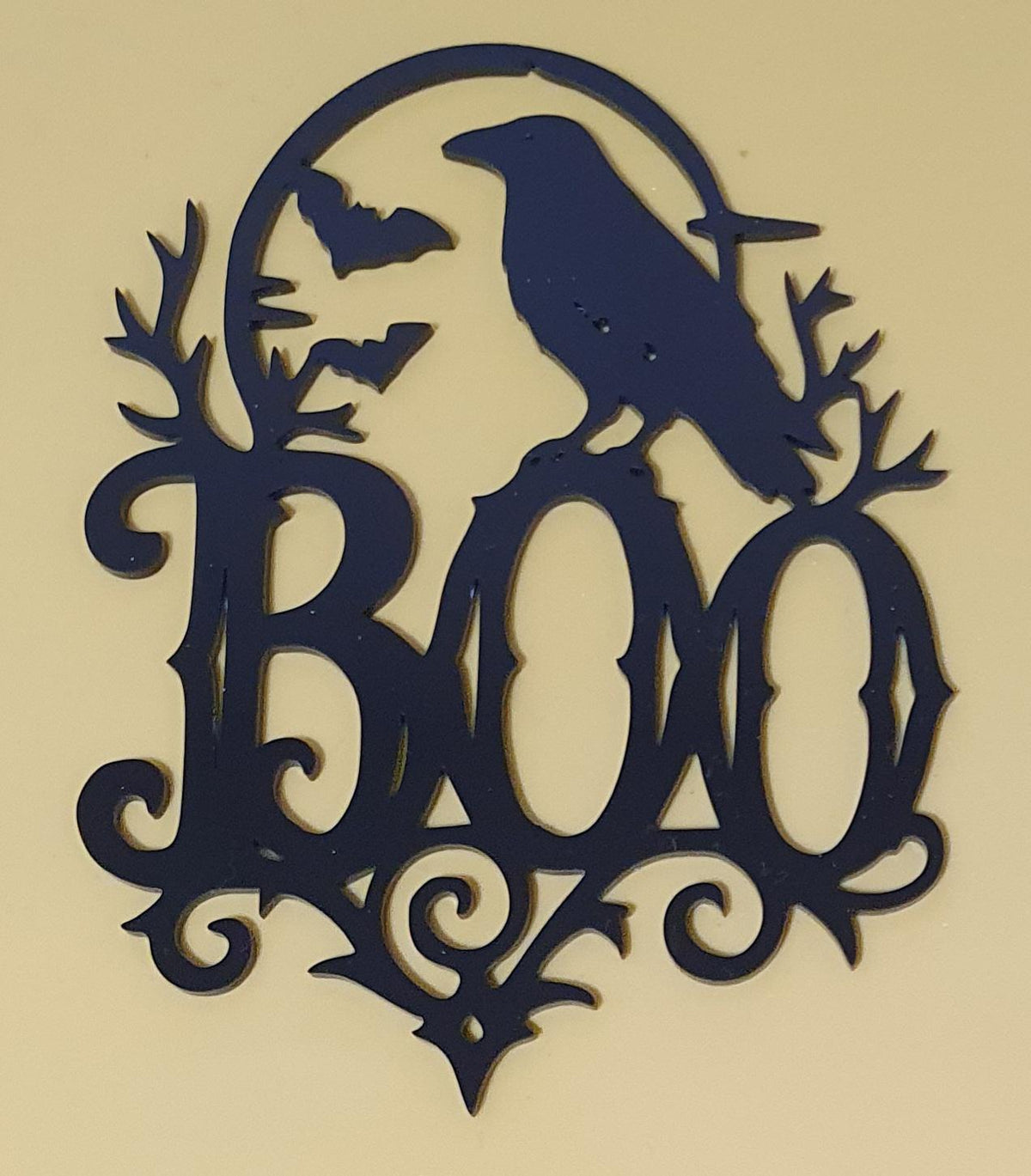 Black laser-cut acrylic BOO Halloween decoration featuring a raven, flying bats, full moon, twisted branches and gothic flourishes.