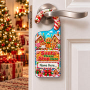 Personalised Santa Please Stop Here door hanger with three smiling gingerbread characters and a space for a child’s name.
