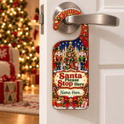 Personalised Santa Please Stop Here Christmas door hanger with two Nutcracker toy soldiers and a space for a child’s name.