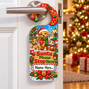 Personalised Santa Paws Christmas door hanger featuring two puppies, a kitten, presents and a space for a name.