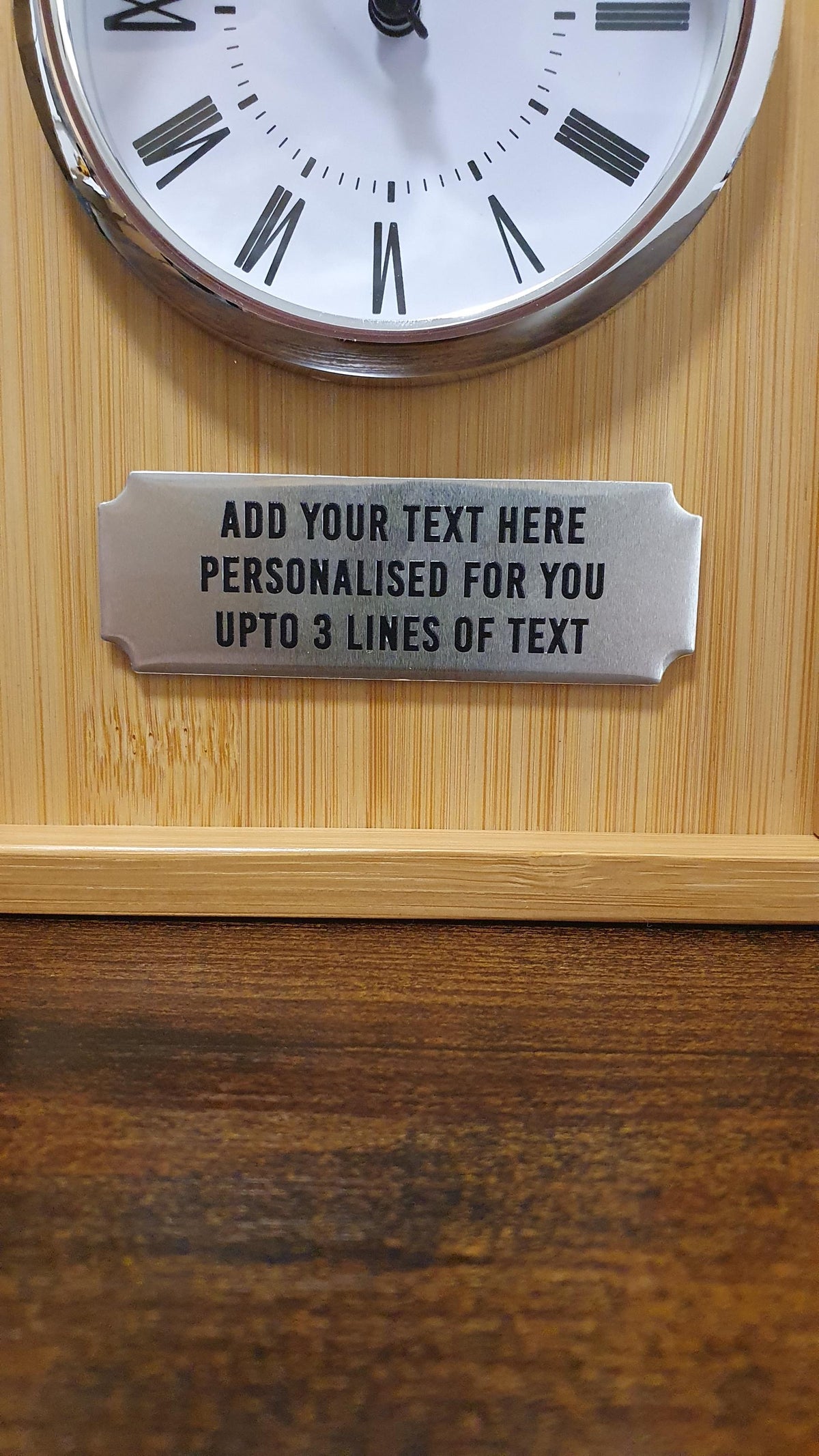 Close-up of the silver-toned plaque showing where up to three lines of personalisation can be added.