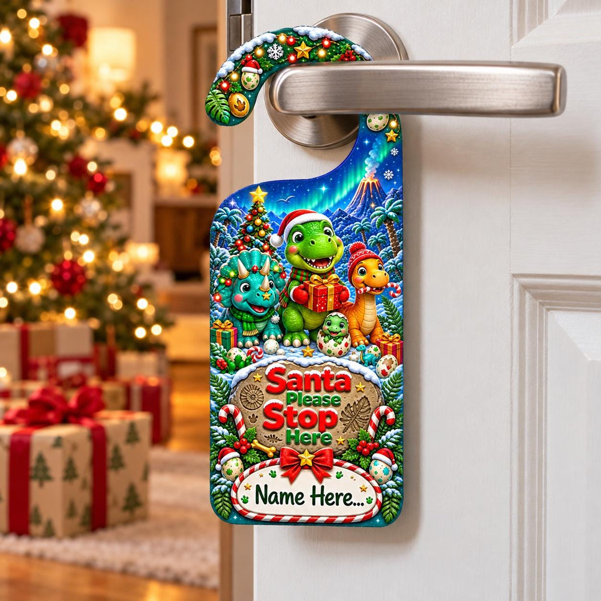 Personalised dinosaur Christmas door hanger showing three festive dinosaurs, presents and the words “Santa Please Stop Here”.
