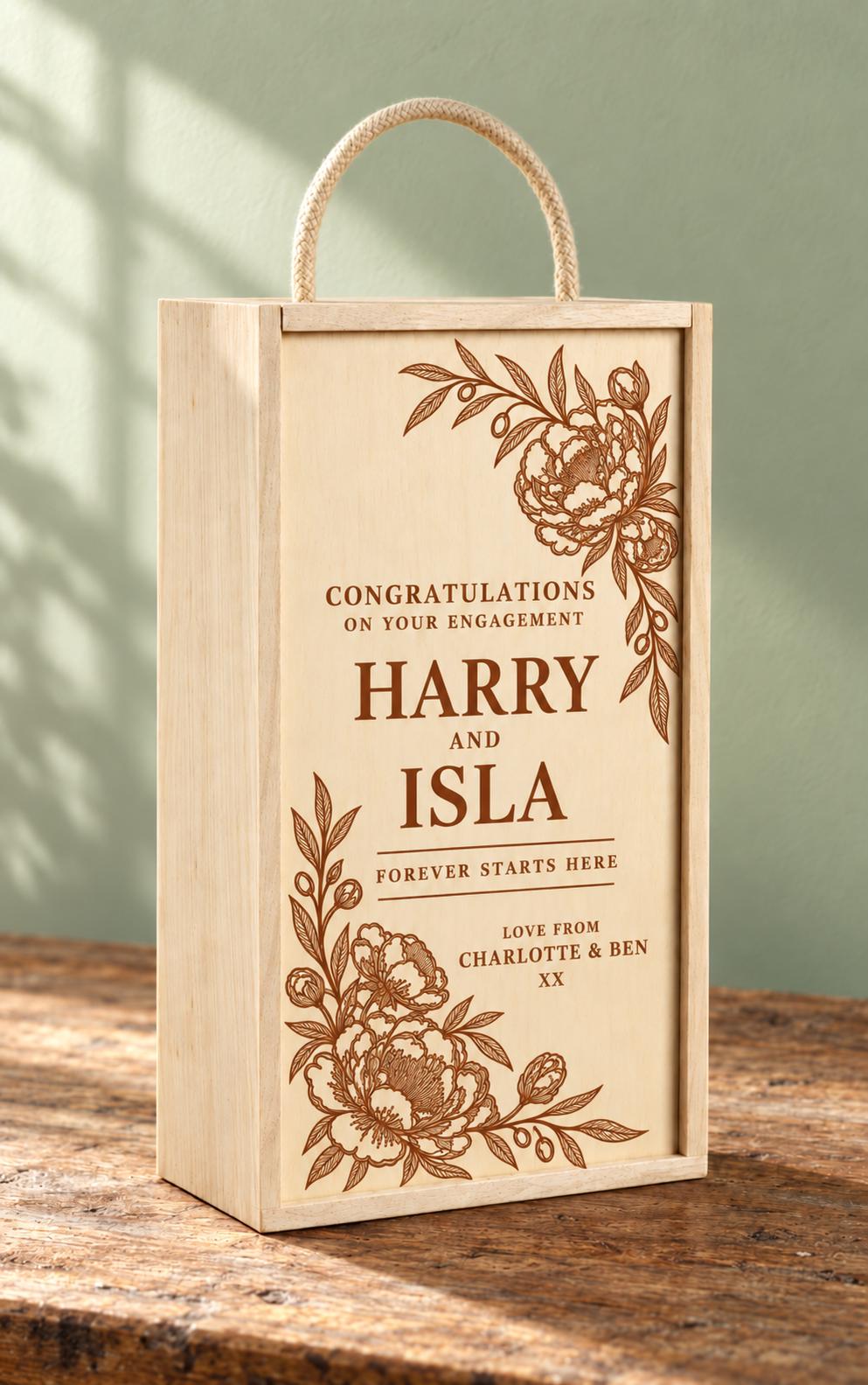Personalised engagement wine gift box for Harry and Isla with floral engraving, a rope handle and the message Forever Starts Here.
