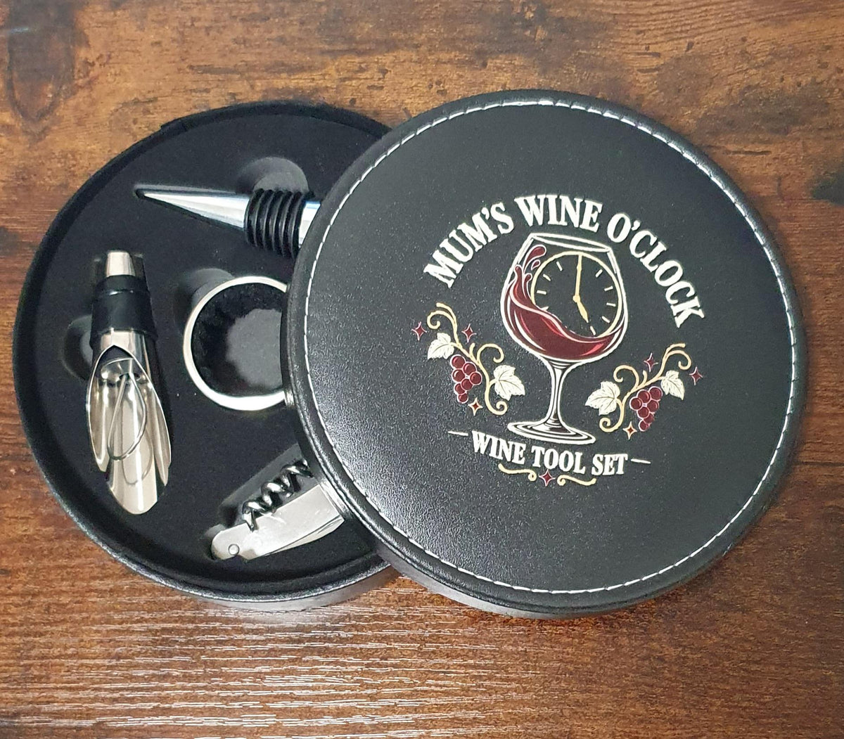 Open Mum’s Wine O’Clock gift case showing the corkscrew, bottle stopper, drip collar and wine pourer.