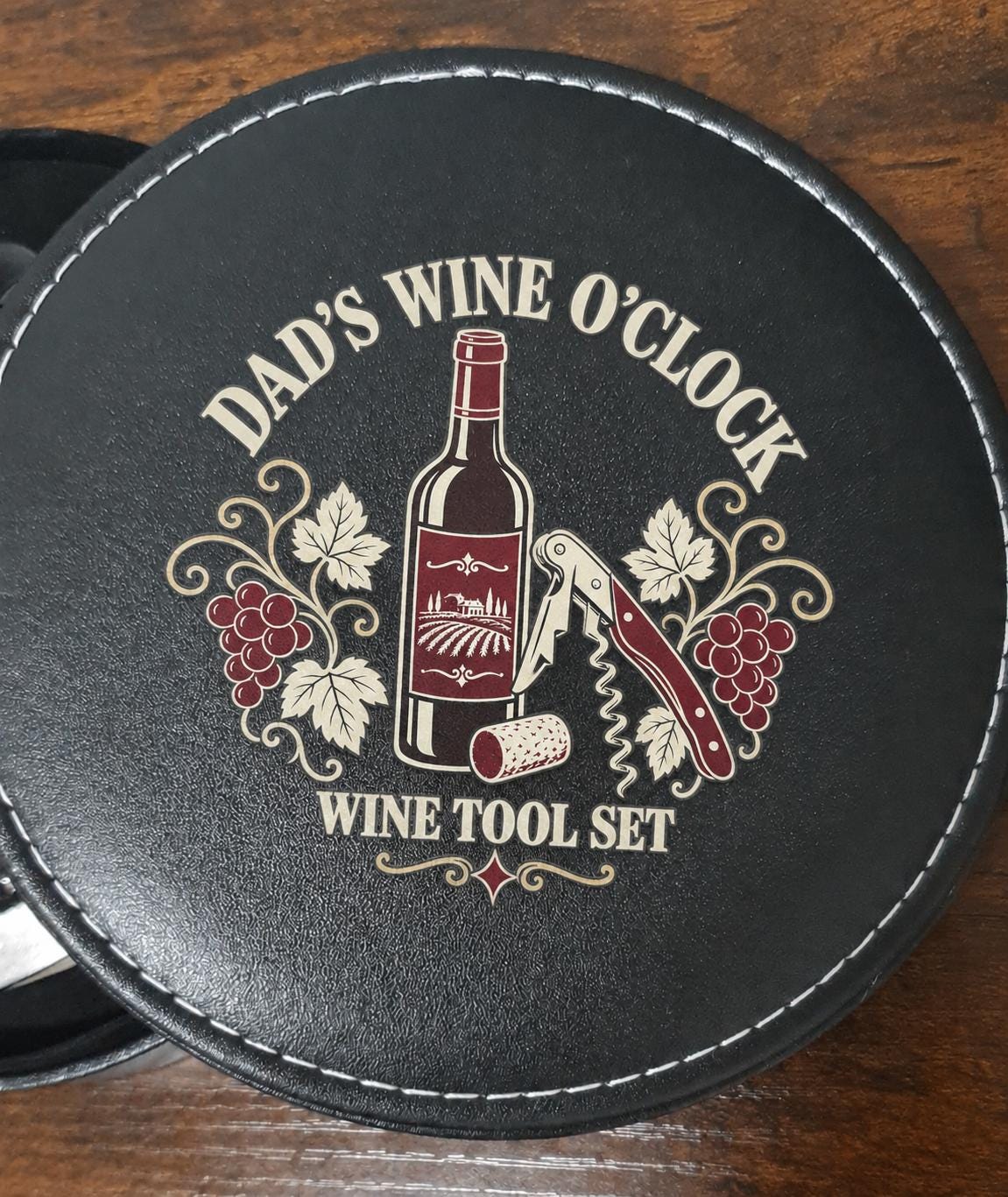 Close-up of the black case lid with “Dad’s Wine O’Clock”, a wine bottle, corkscrew and grape design.