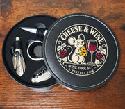 Open round wine tool case showing four accessories and the Cheese & Wine mouse design printed on the lid.