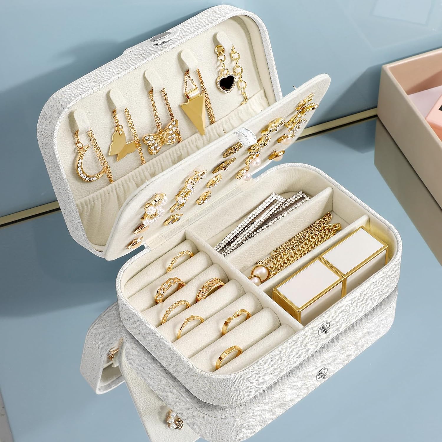 Travel jewellery organiser personalised with any name, decorated with soft tropical flowers and leaves, perfect for safely storing precious jewellery at home or while travelling.