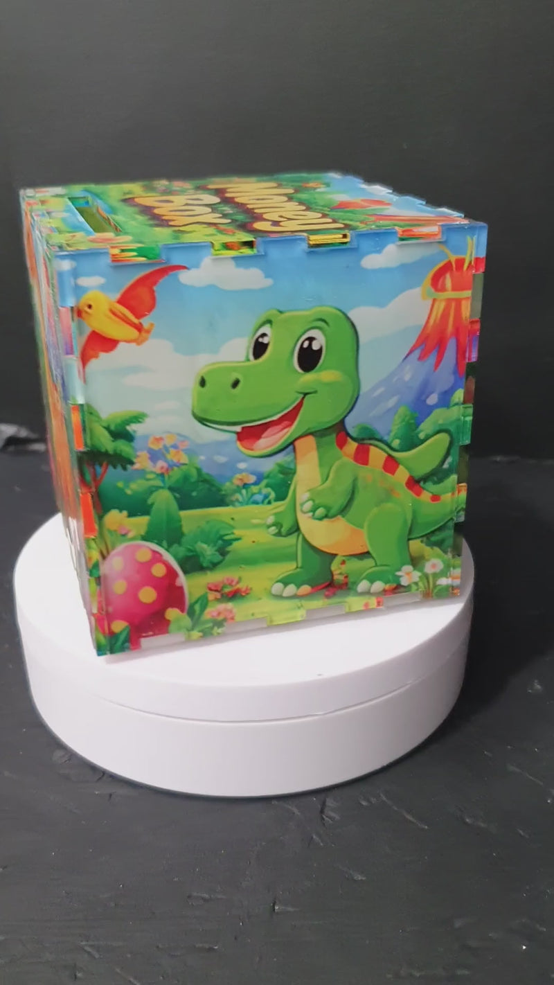 Front view of baby dino money box with “Money Box” text on lid and coin slot, colourful nursery savings bank.
