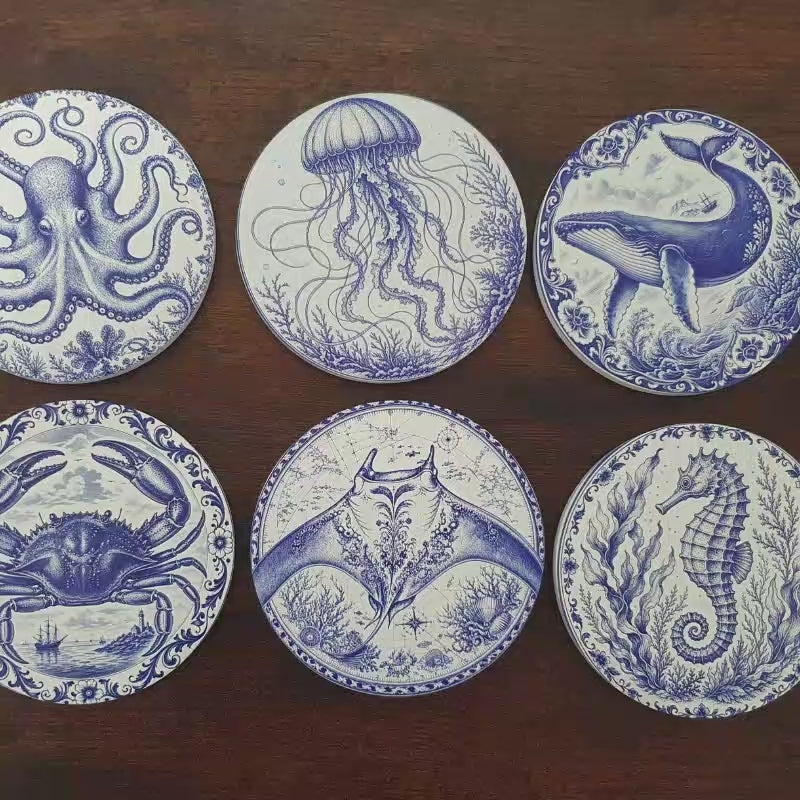 Load video: Set of six ceramic sea creature coasters featuring cobalt blue illustrations of ocean animals with cork backing.